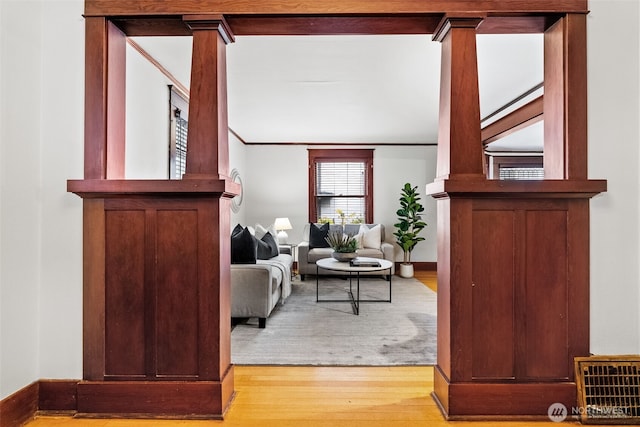 interior space with crown molding and wood-type flooring