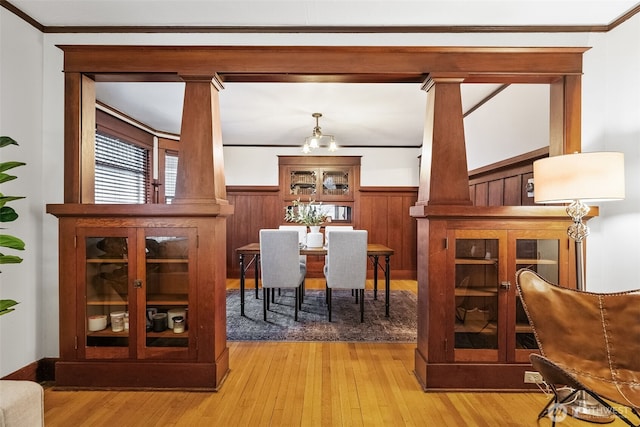 sitting room featuring light wood-type flooring and ornamental molding