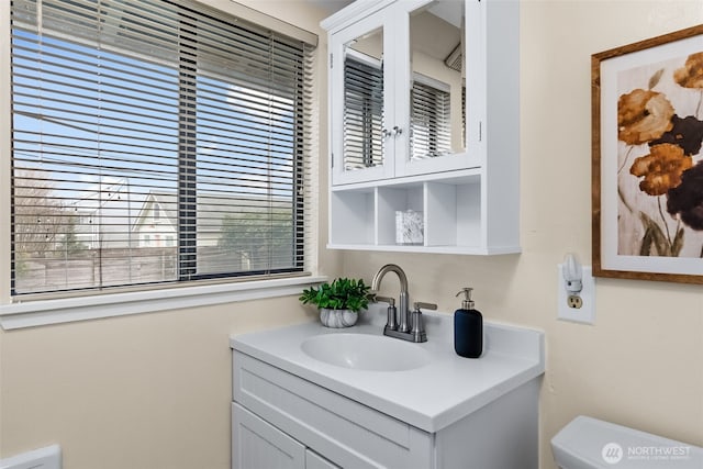 bathroom with toilet and vanity