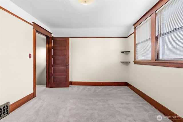 unfurnished room with light colored carpet