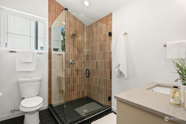 bathroom with tile patterned floors, vanity, toilet, and an enclosed shower