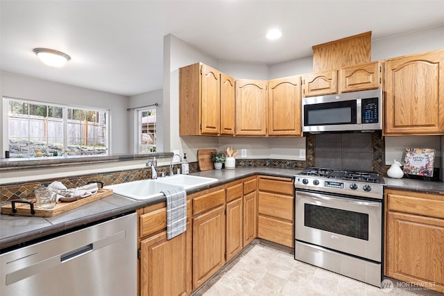 kitchen featuring stainless steel appliances, sink, and decorative backsplash