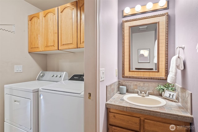 clothes washing area featuring sink and washing machine and dryer