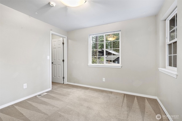 spare room with light colored carpet