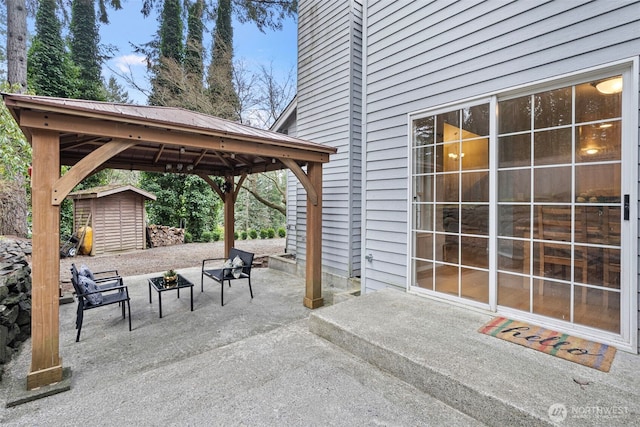 view of patio featuring a gazebo and a storage unit