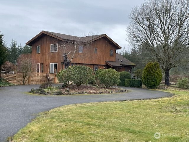 view of side of home with a yard