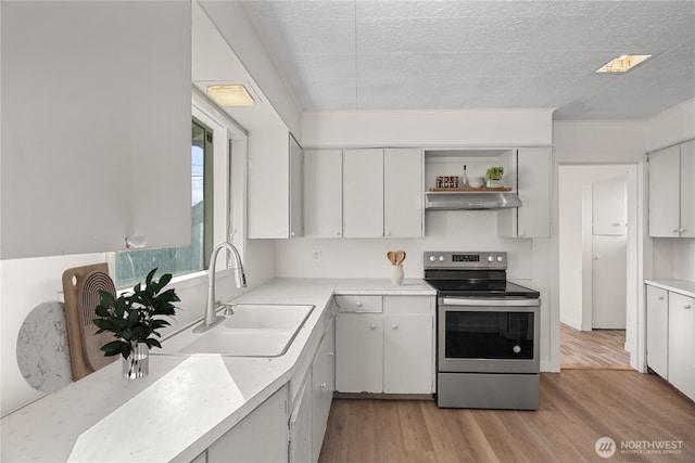 kitchen featuring white cabinetry, sink, light wood-type flooring, and stainless steel electric range oven