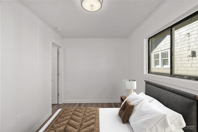 bedroom featuring crown molding and hardwood / wood-style floors