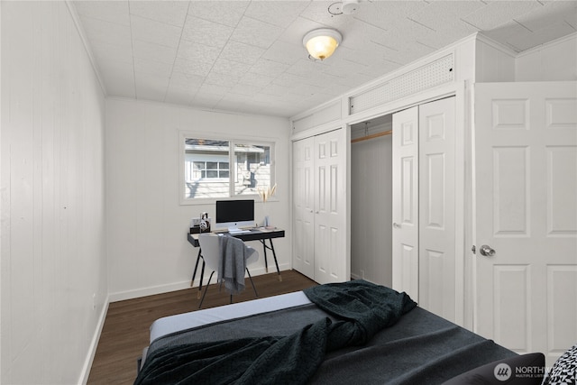 bedroom with crown molding and dark hardwood / wood-style floors