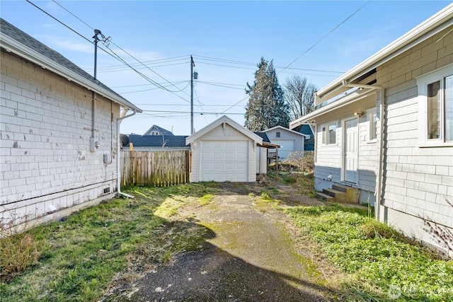 view of yard featuring a garage and an outdoor structure