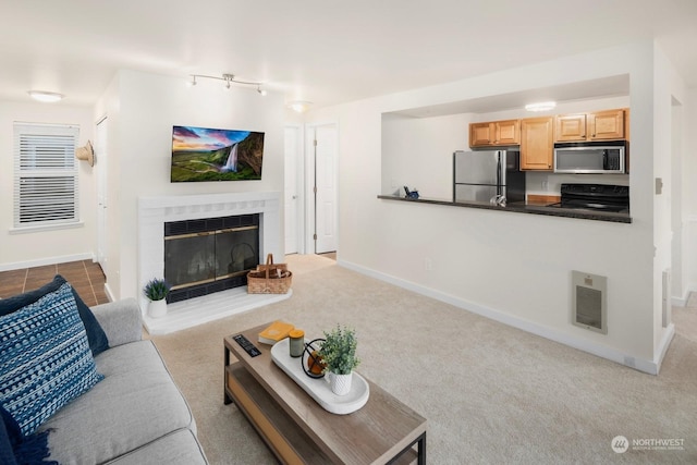 carpeted living room with a fireplace