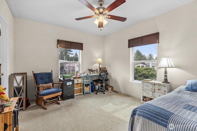 bedroom with light colored carpet and ceiling fan