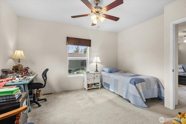 bedroom featuring light carpet and a ceiling fan