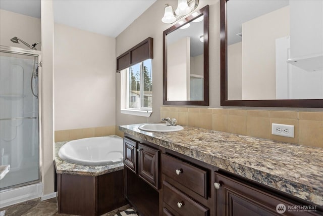 bathroom featuring a garden tub, tasteful backsplash, a shower stall, and vanity