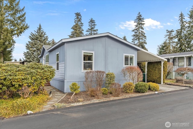 view of property exterior featuring an attached carport