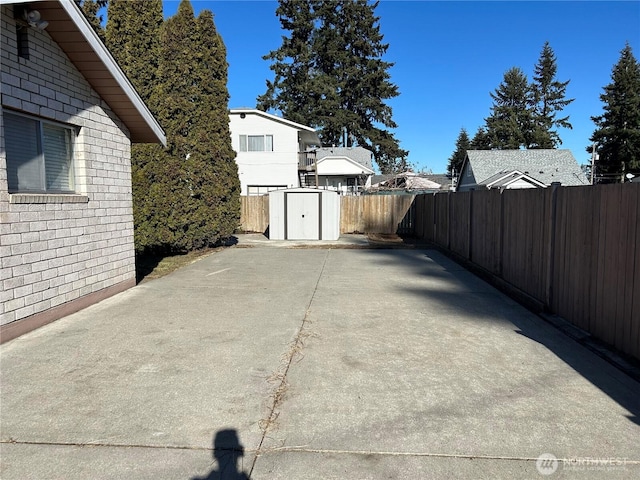 view of patio featuring a storage unit