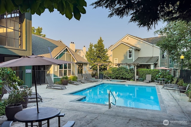 pool with fence and a patio