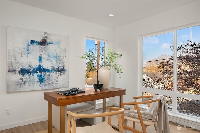 home office with light hardwood / wood-style floors