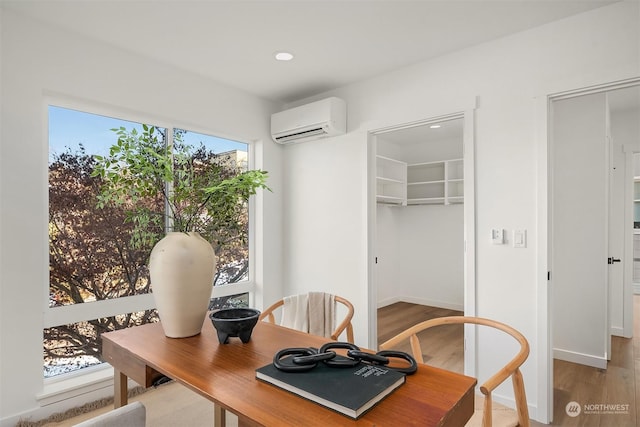 dining area with wood-type flooring and a wall mounted AC