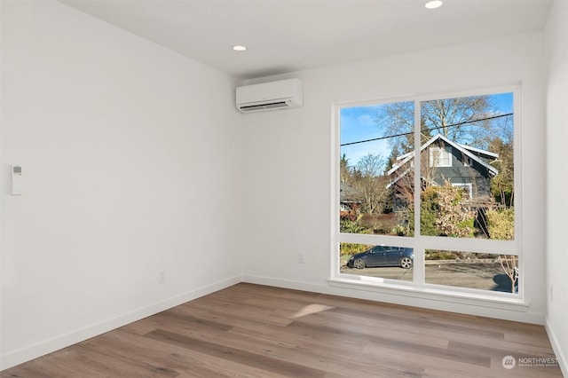 unfurnished dining area with hardwood / wood-style flooring and an AC wall unit