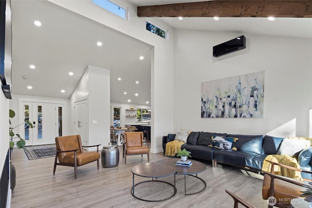 living room featuring beamed ceiling, high vaulted ceiling, light wood-type flooring, and french doors