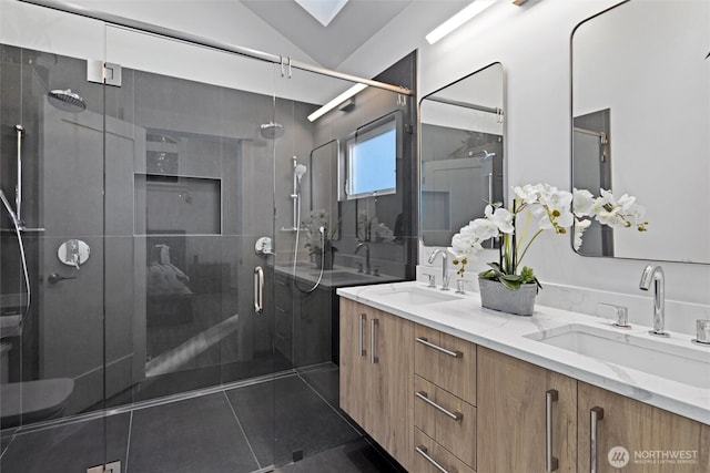 bathroom featuring vanity, tile patterned flooring, a shower with door, and lofted ceiling