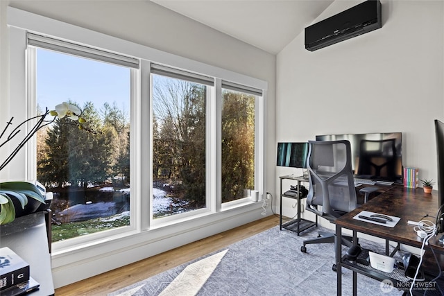 office area featuring wood-type flooring, an AC wall unit, and lofted ceiling