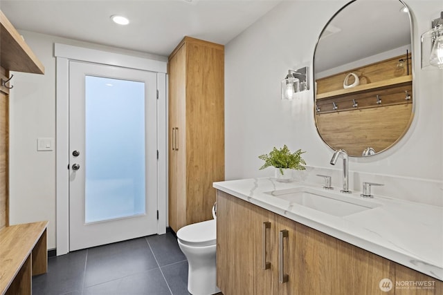 bathroom with tile patterned flooring, vanity, and toilet