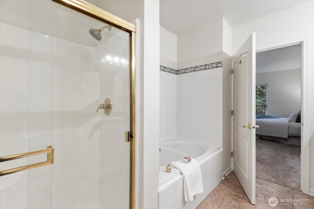 ensuite bathroom with tile patterned floors, ensuite bath, a bath, and a shower stall