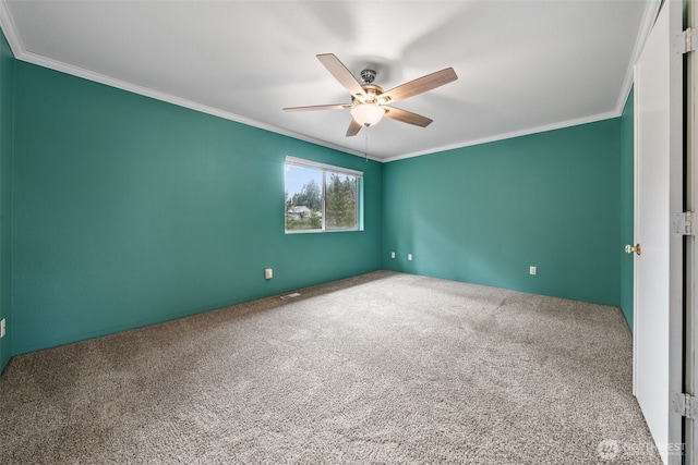 carpeted empty room with crown molding and ceiling fan