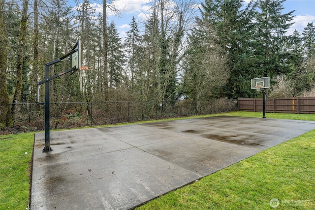 view of sport court with basketball court and fence