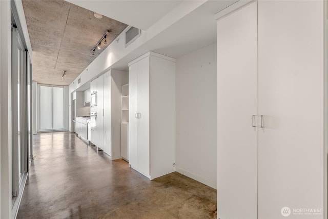 corridor featuring visible vents and concrete floors