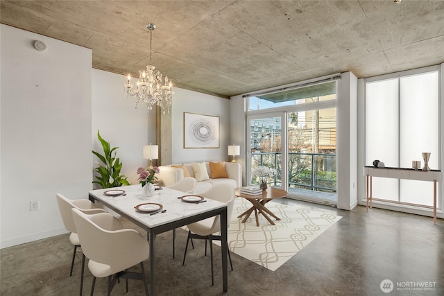 dining room featuring baseboards, a baseboard radiator, expansive windows, concrete flooring, and a chandelier