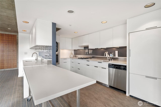 kitchen with a sink, white cabinetry, stainless steel appliances, and light countertops