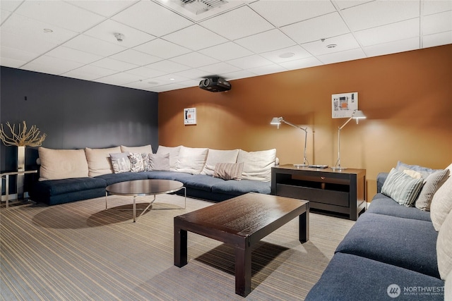 living room with light carpet, visible vents, and a drop ceiling