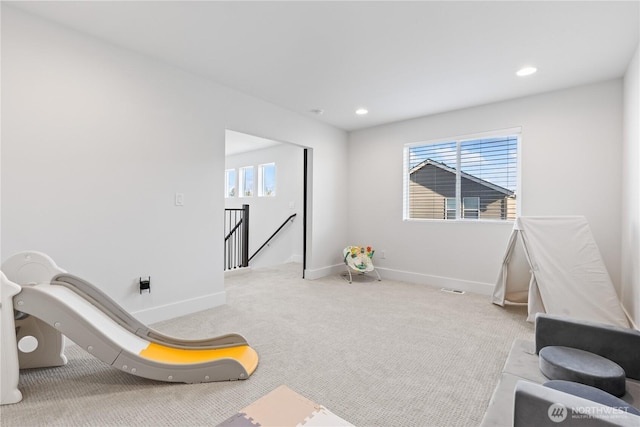 rec room featuring a wealth of natural light and light colored carpet