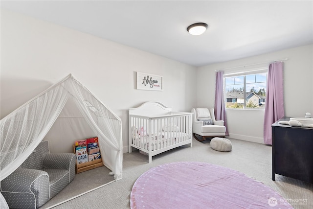 carpeted bedroom featuring a crib