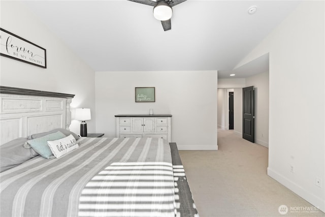 carpeted bedroom featuring ceiling fan and vaulted ceiling