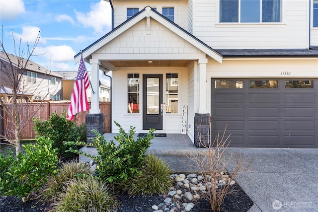 view of front of home featuring a garage and a porch