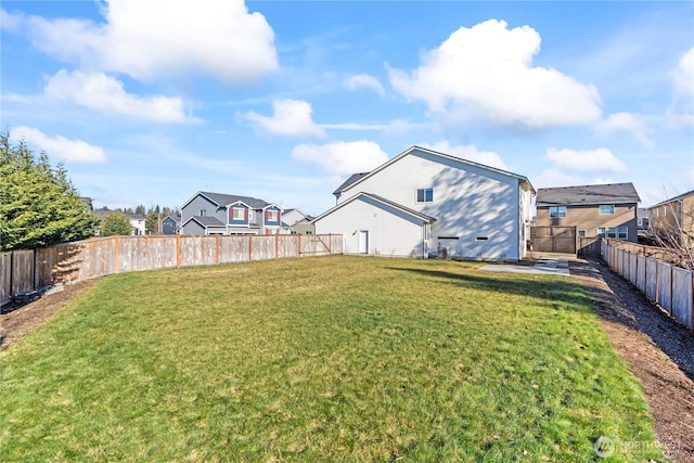 view of yard featuring a residential view and a fenced backyard