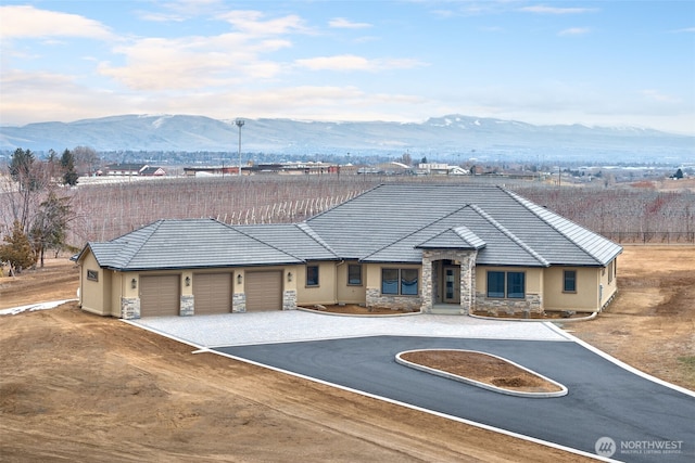 view of front of house featuring a garage and a mountain view