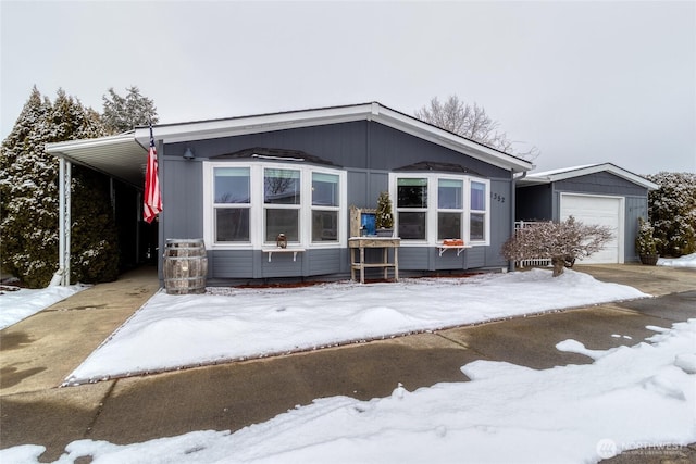 view of front of home featuring an outbuilding, a garage, and a carport