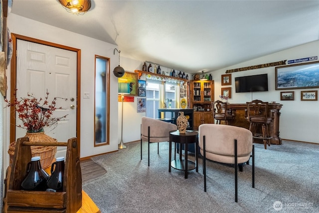 dining room featuring bar and vaulted ceiling