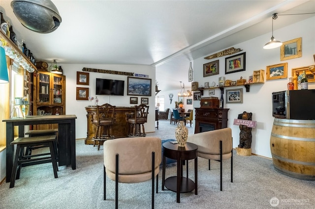 living room featuring bar, carpet floors, and lofted ceiling