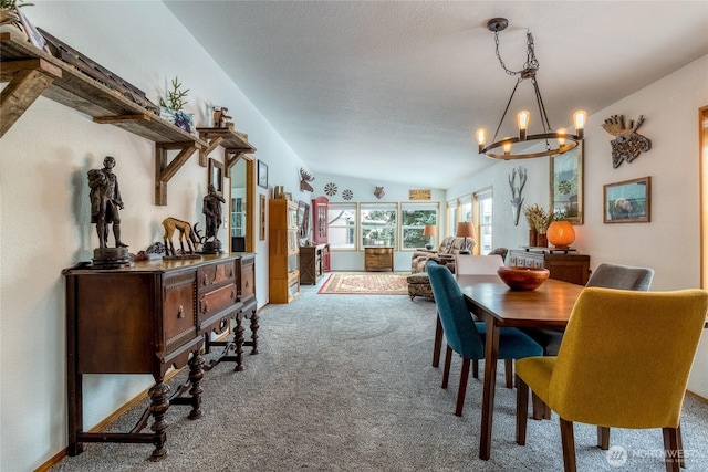 dining space with lofted ceiling, carpet floors, a textured ceiling, and a notable chandelier