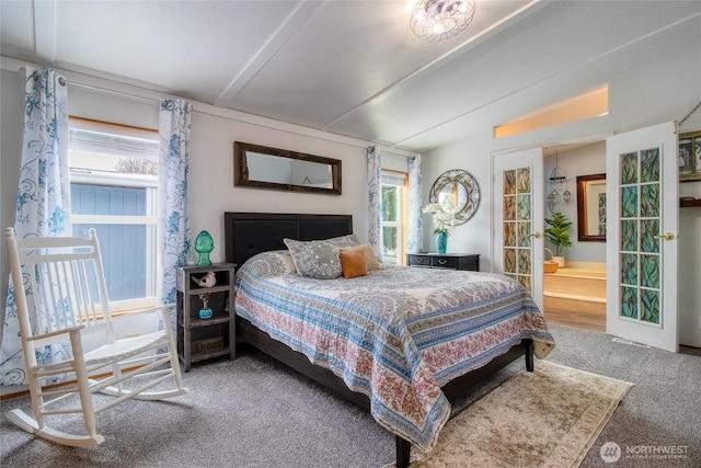 carpeted bedroom with french doors, lofted ceiling, and connected bathroom