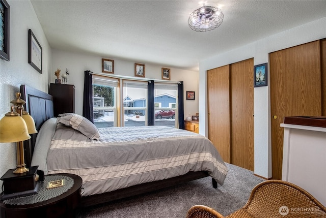 bedroom featuring carpet and a textured ceiling