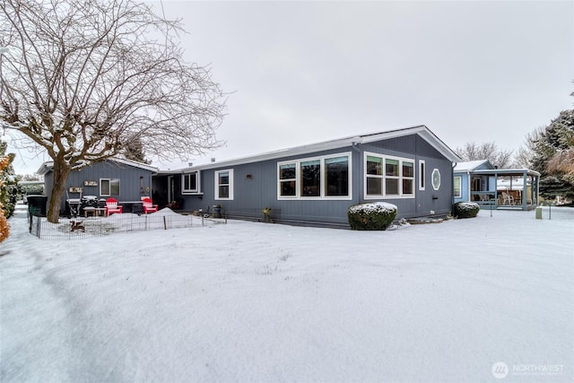 view of snow covered rear of property