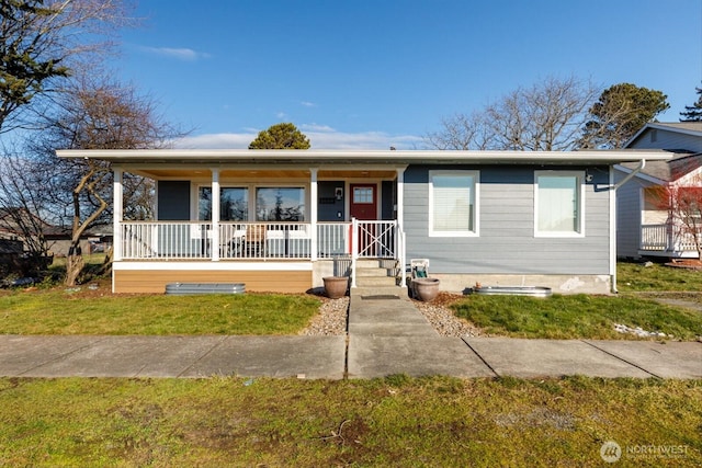 bungalow-style house with covered porch and a front lawn