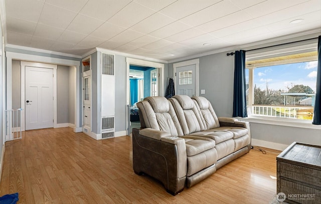 living room with ornamental molding and hardwood / wood-style floors